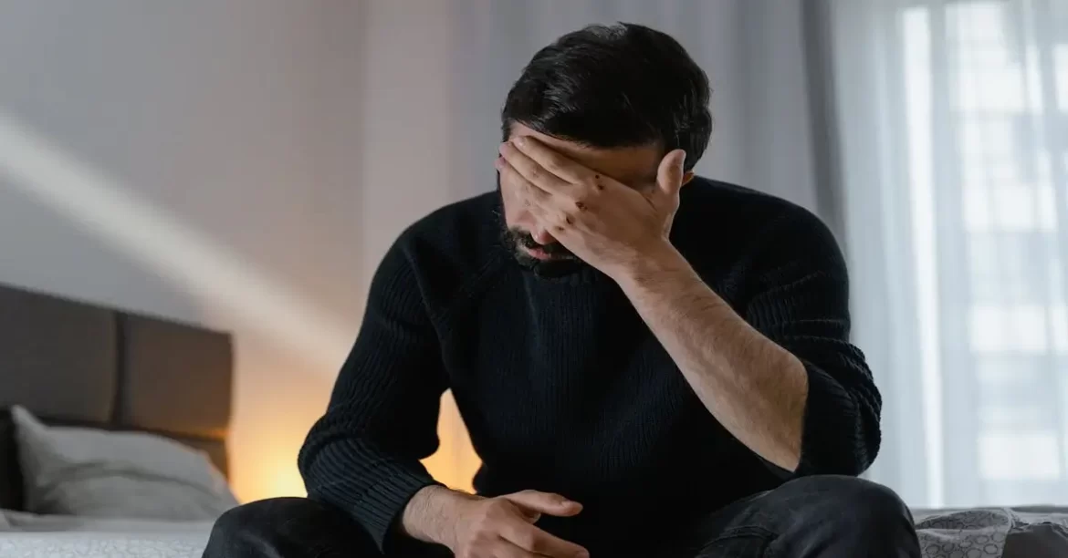 a man with his hand on his face